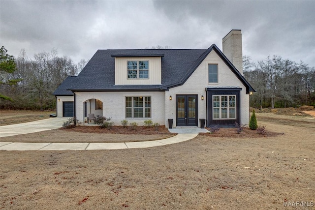 view of front of property with french doors and a garage