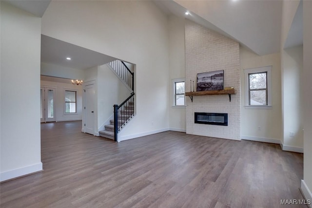 unfurnished living room with a fireplace, light hardwood / wood-style flooring, and a wealth of natural light