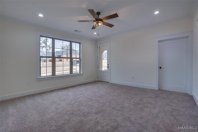 spare room featuring carpet flooring, ceiling fan, and crown molding