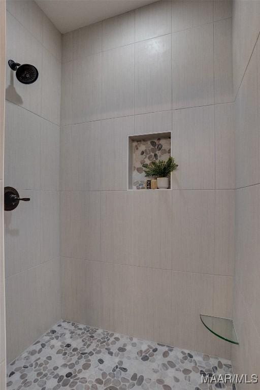 bathroom with a tile shower