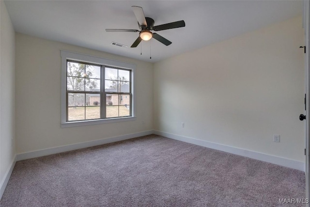 carpeted spare room featuring ceiling fan