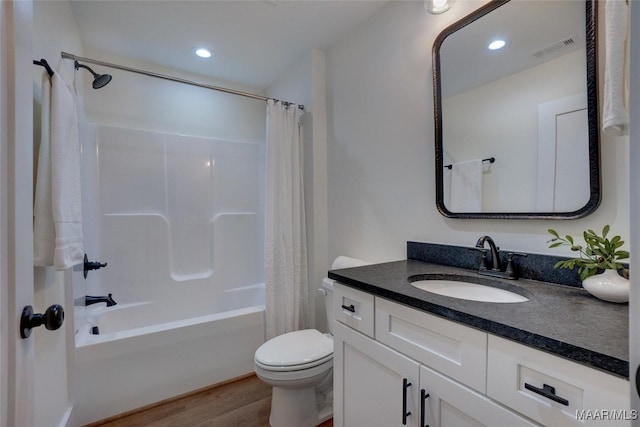 full bathroom with hardwood / wood-style flooring, vanity, toilet, and shower / bathtub combination with curtain