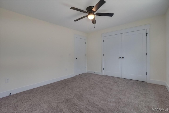 unfurnished bedroom with ceiling fan, light colored carpet, and a closet