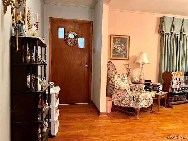 entrance foyer featuring hardwood / wood-style floors and ornamental molding