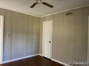 unfurnished bedroom featuring ceiling fan and dark hardwood / wood-style floors