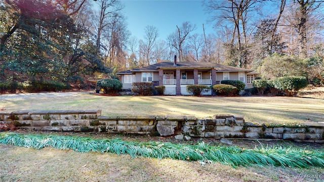 back of house featuring a lawn