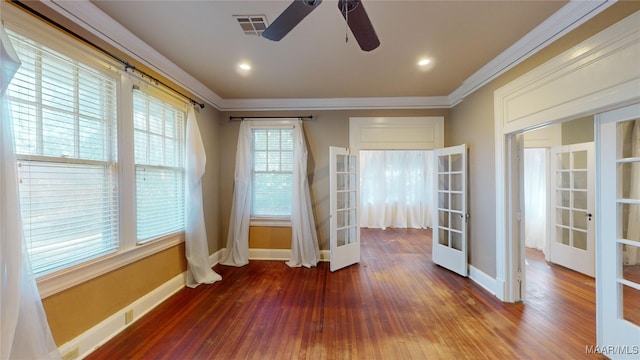 entryway featuring hardwood / wood-style flooring, ceiling fan, ornamental molding, and french doors