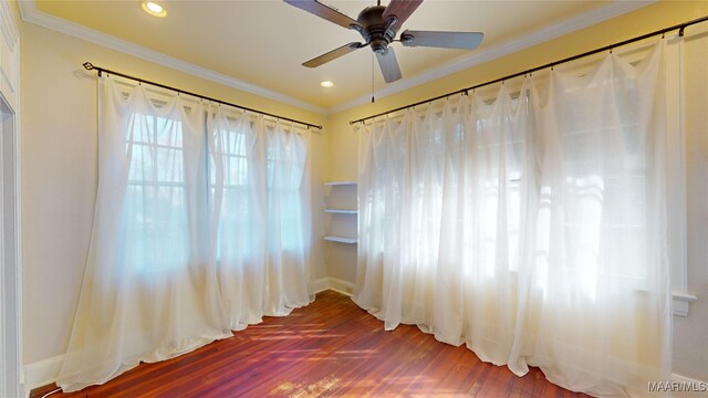 empty room with crown molding, ceiling fan, and hardwood / wood-style floors