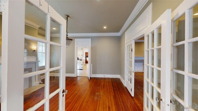 hall with dark hardwood / wood-style flooring, french doors, and ornamental molding