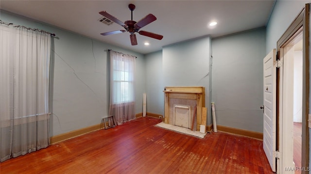 unfurnished living room with ceiling fan and hardwood / wood-style floors