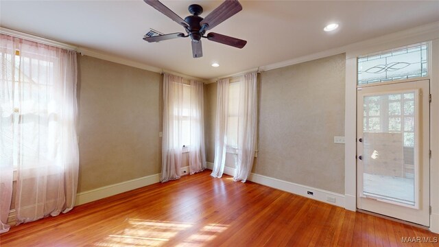 unfurnished room featuring ceiling fan, ornamental molding, and hardwood / wood-style flooring