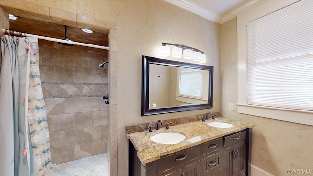 bathroom featuring a shower with curtain, ornamental molding, and vanity