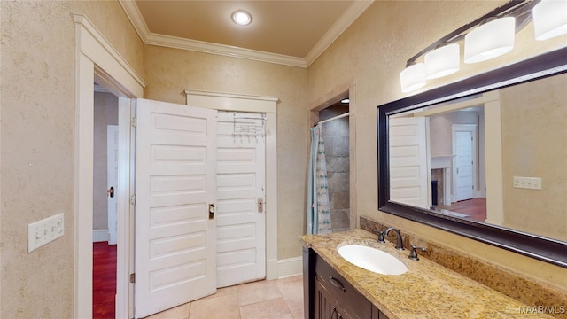 bathroom with walk in shower, tile patterned floors, ornamental molding, and vanity