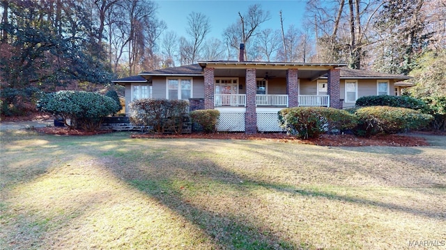 single story home featuring a porch and a front lawn