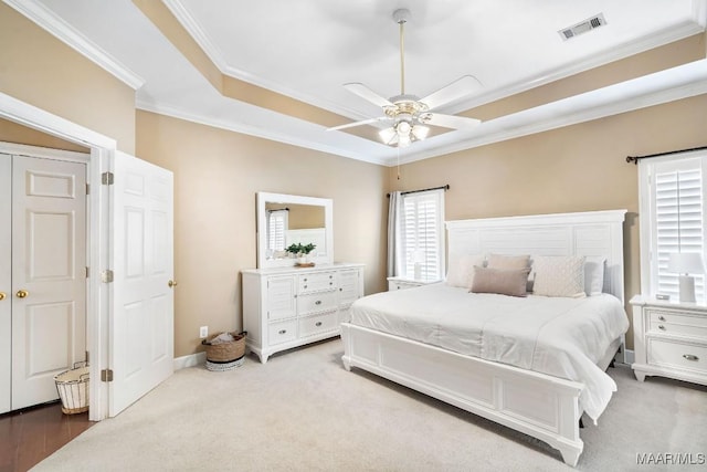 bedroom featuring light carpet, ceiling fan, and ornamental molding