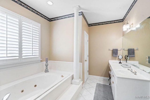 bathroom with tile patterned flooring, vanity, a tub to relax in, and decorative columns