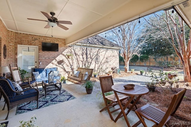 view of patio / terrace with an outdoor living space and ceiling fan