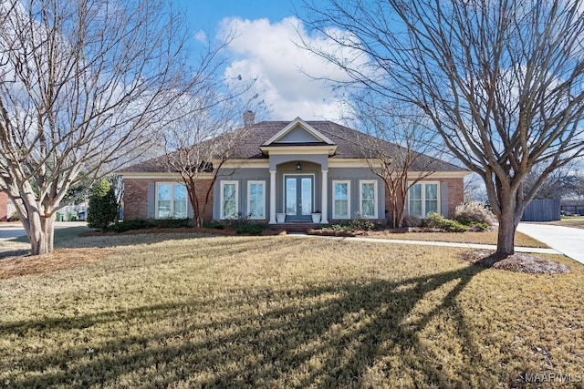 ranch-style house with french doors and a front yard