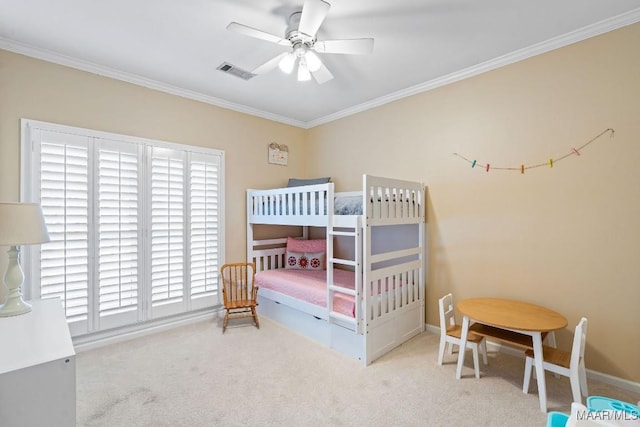 carpeted bedroom with ceiling fan and ornamental molding