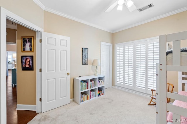 rec room with light carpet, ceiling fan, and crown molding