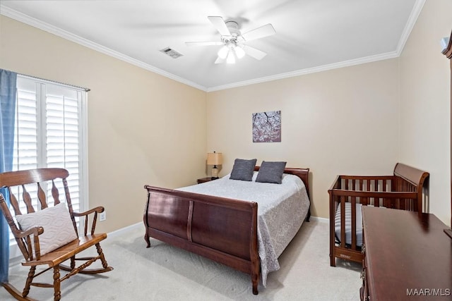 carpeted bedroom with ceiling fan and ornamental molding