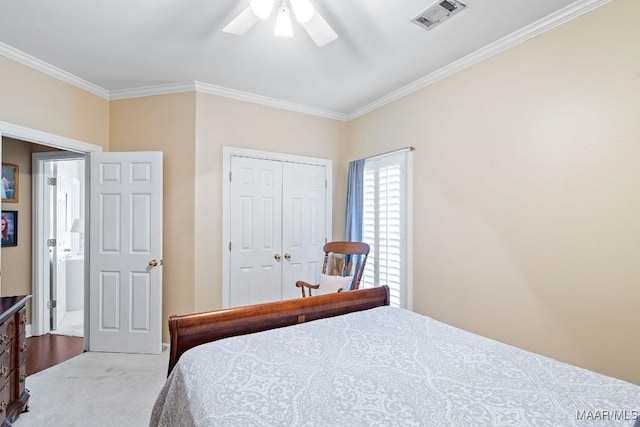 bedroom featuring ceiling fan, light colored carpet, crown molding, and a closet