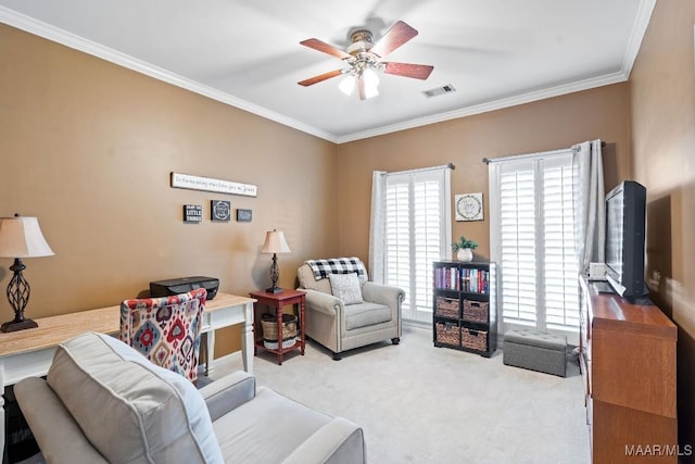 carpeted living room with ceiling fan and ornamental molding