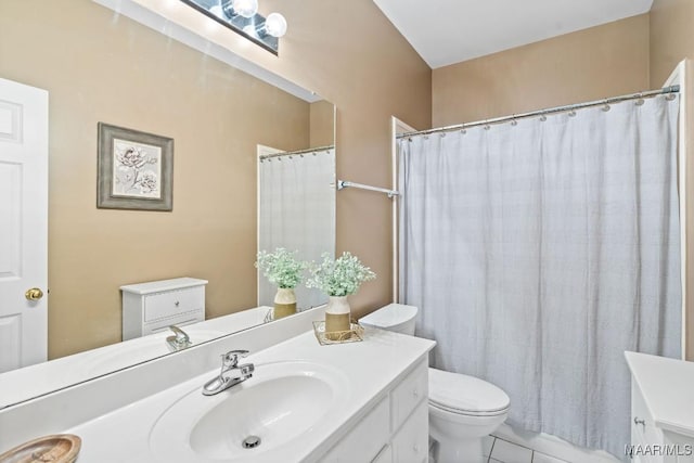 bathroom featuring tile patterned floors, vanity, and toilet