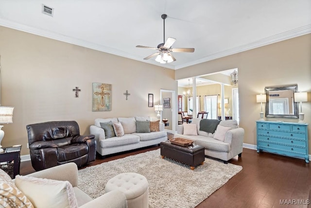 living room featuring ceiling fan with notable chandelier, dark hardwood / wood-style floors, and ornamental molding