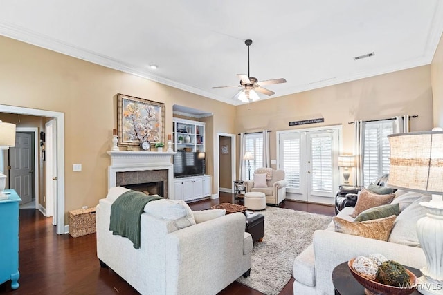 living room with ceiling fan, a healthy amount of sunlight, dark wood-type flooring, and french doors