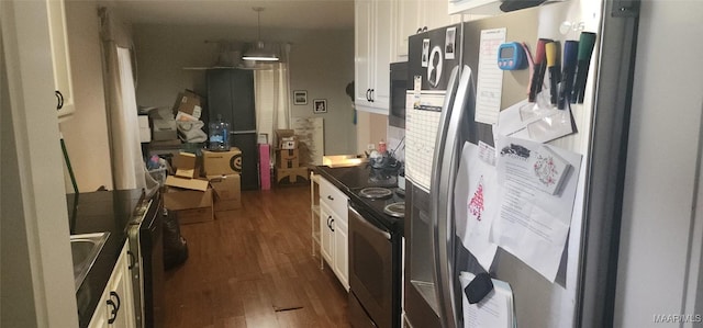 kitchen featuring dark hardwood / wood-style floors, stainless steel fridge, pendant lighting, electric stove, and white cabinets