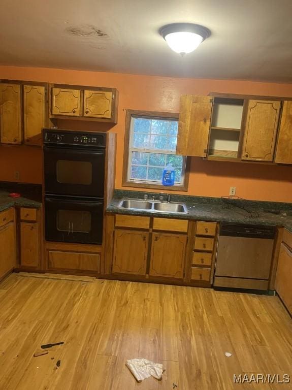 kitchen with stainless steel dishwasher, light hardwood / wood-style floors, sink, and double oven