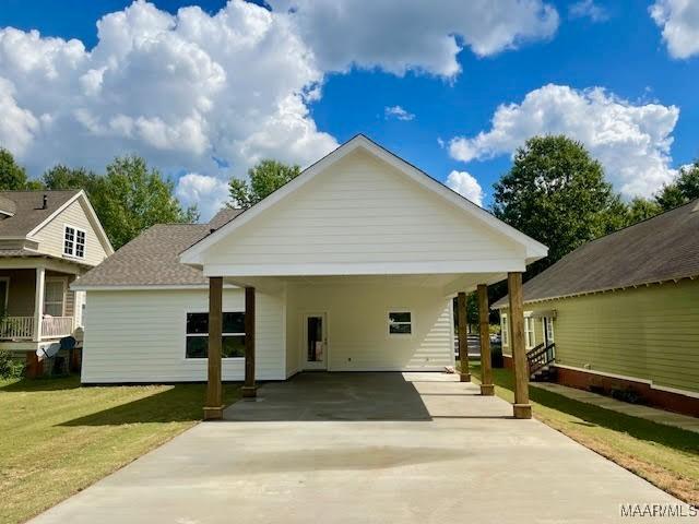 view of front of home featuring a front lawn and a carport