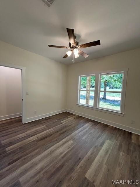 unfurnished room featuring ceiling fan and dark wood-type flooring