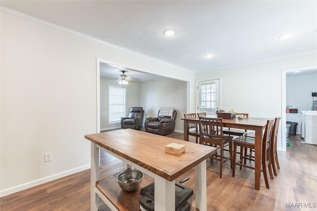 dining area with ceiling fan and wood-type flooring