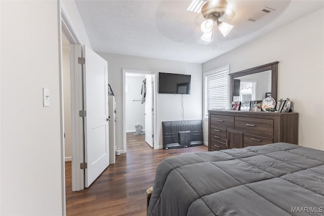 bedroom featuring ceiling fan, dark hardwood / wood-style floors, and a textured ceiling