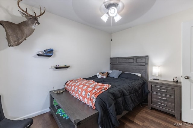 bedroom with dark hardwood / wood-style floors and ceiling fan