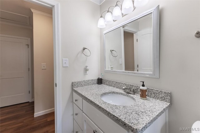 bathroom with vanity, hardwood / wood-style flooring, and ornamental molding