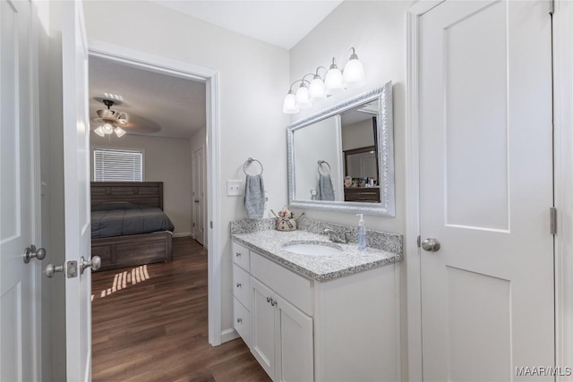 bathroom with ceiling fan, hardwood / wood-style floors, and vanity