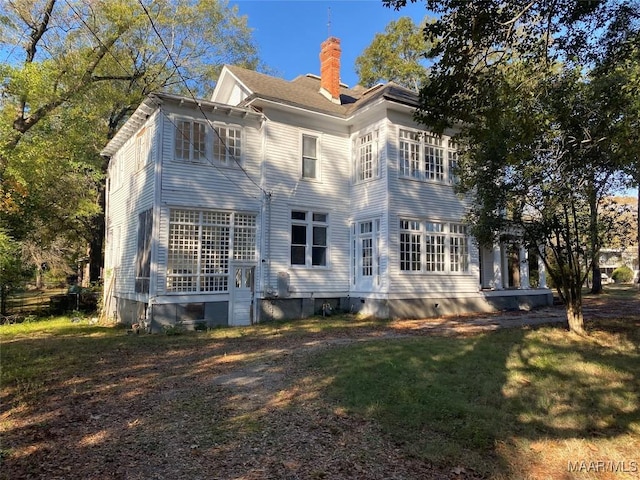 rear view of house with a lawn