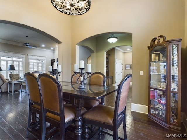 8513 Rockbridge Cir, Montgomery, AL 36116 - dining space with arched walkways, dark wood-style flooring, a ceiling fan, crown molding, and baseboards
