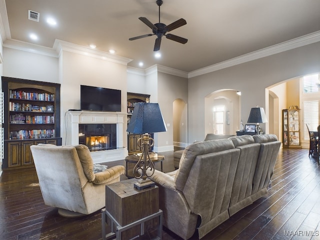 8513 Rockbridge Cir, Montgomery, AL 36116 - living room featuring arched walkways, ceiling fan, dark wood finished floors, ornamental molding, and a fireplace
