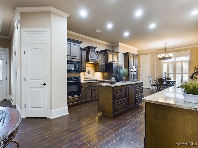 8513 Rockbridge Cir, Montgomery, AL 36116 - kitchen featuring black appliances, a center island, dark wood-type flooring, a chandelier, and ornamental molding