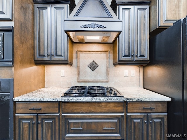 8513 Rockbridge Cir, Montgomery, AL 36116 - kitchen with black appliances, premium range hood, backsplash, and dark brown cabinetry