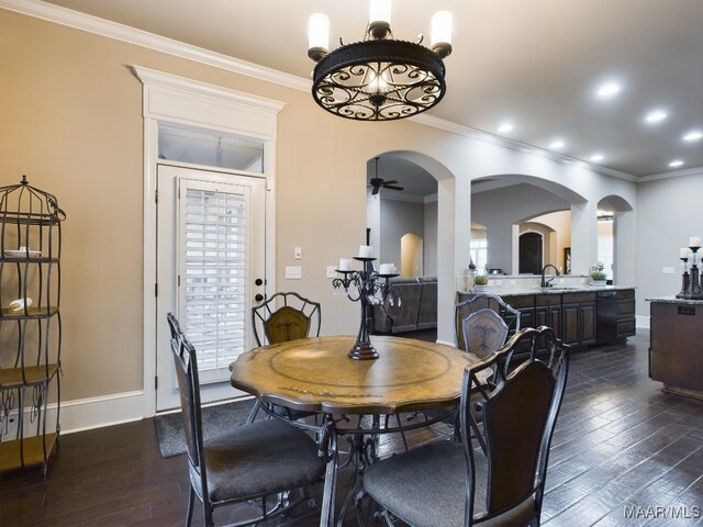 8513 Rockbridge Cir, Montgomery, AL 36116 - dining room featuring dark wood-style flooring, arched walkways, crown molding, ceiling fan, and baseboards