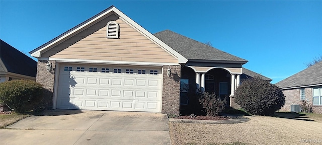 front of property featuring cooling unit and a garage