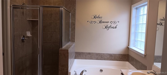 bathroom featuring vanity, separate shower and tub, and a wealth of natural light