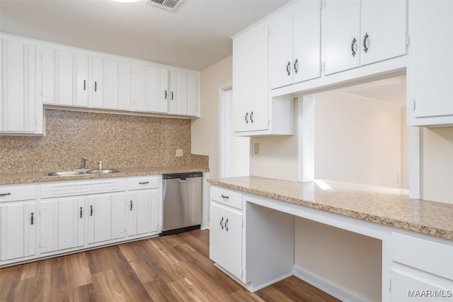 kitchen with stainless steel dishwasher, white cabinets, and sink