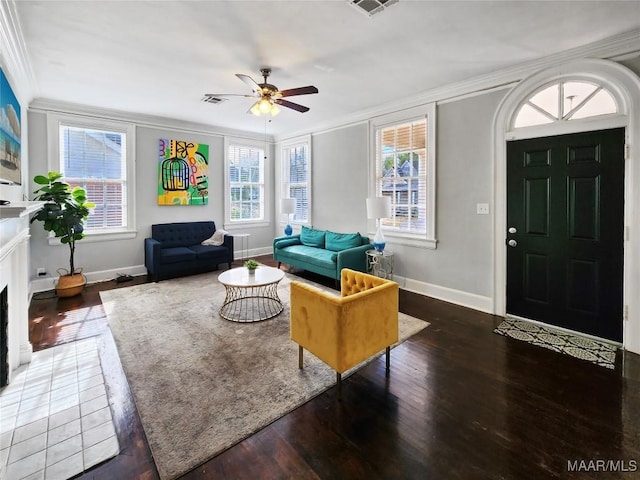 living room with a fireplace, dark hardwood / wood-style floors, ceiling fan, and ornamental molding