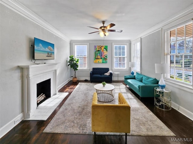 living room with a wealth of natural light, ceiling fan, and ornamental molding